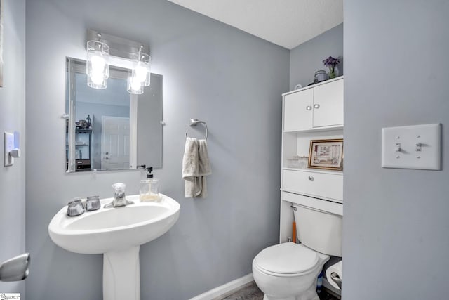 bathroom featuring a textured ceiling and toilet