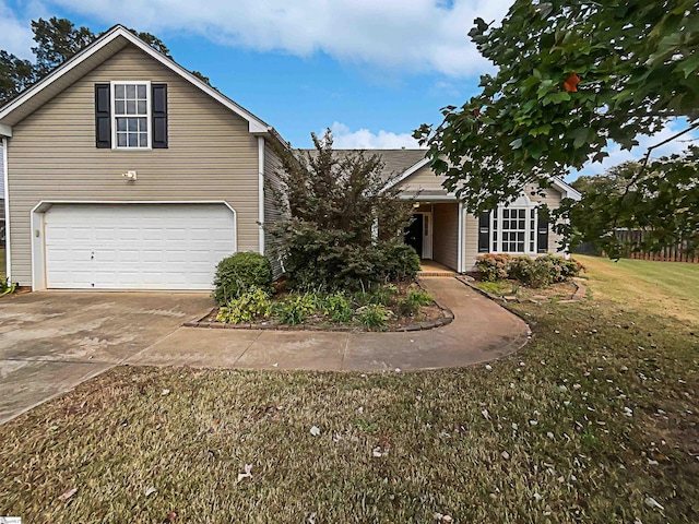 view of front of house featuring a garage and a front lawn