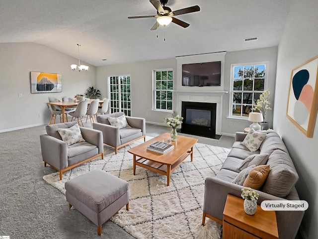 living room with lofted ceiling, light carpet, a textured ceiling, and ceiling fan with notable chandelier