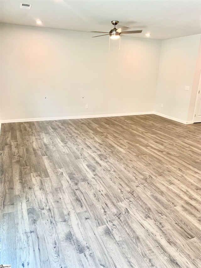 empty room with wood-type flooring and ceiling fan