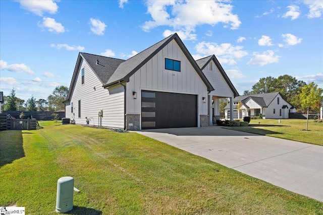 modern farmhouse style home with a front yard and a garage