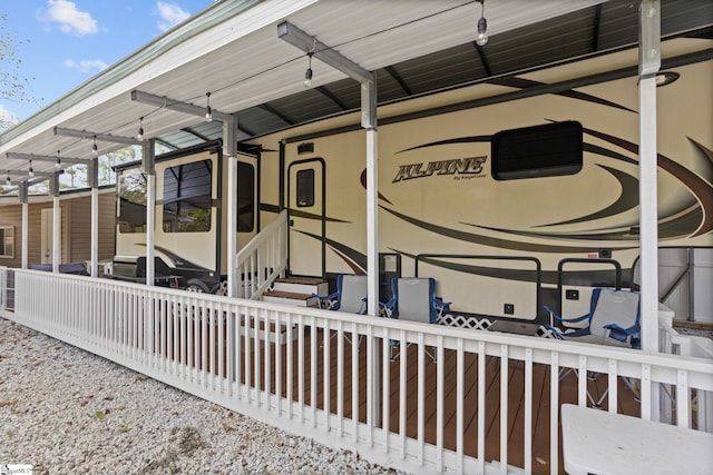rear view of property featuring a carport and entry steps