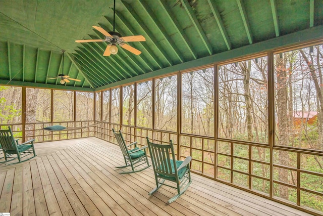 unfurnished sunroom with lofted ceiling and ceiling fan