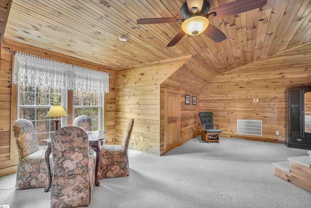 sitting room with wood ceiling, wood walls, carpet flooring, and vaulted ceiling