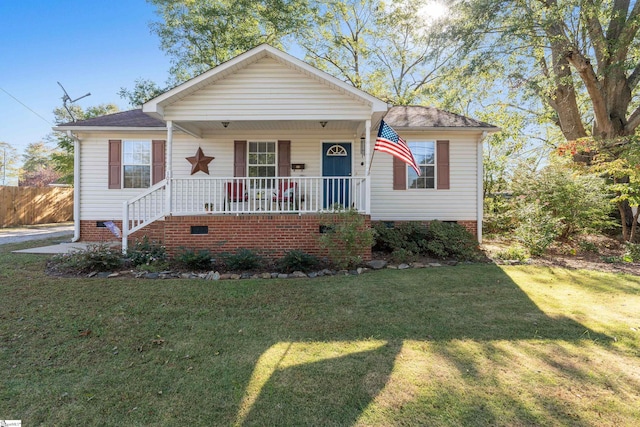 bungalow with a front yard and covered porch