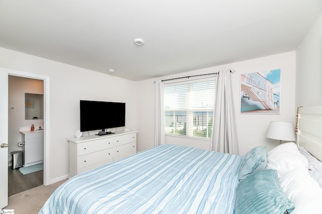 carpeted bedroom featuring ensuite bath