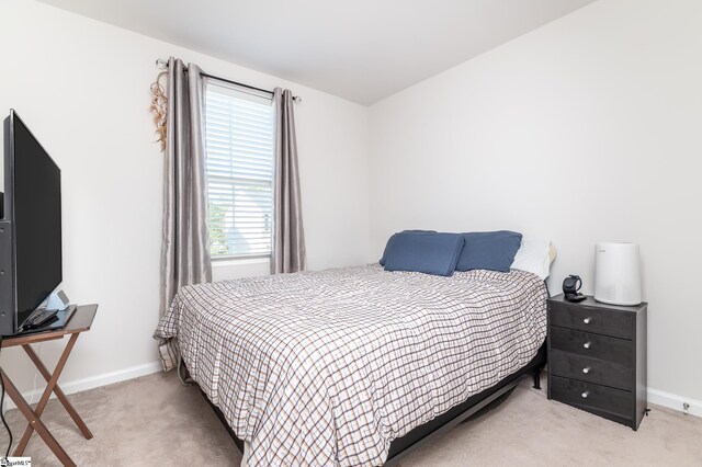 bedroom featuring light carpet