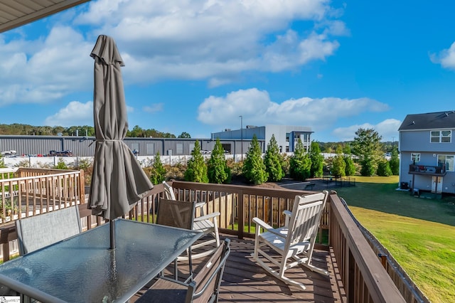 wooden deck featuring a yard