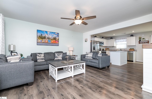 living room with ceiling fan and dark hardwood / wood-style flooring