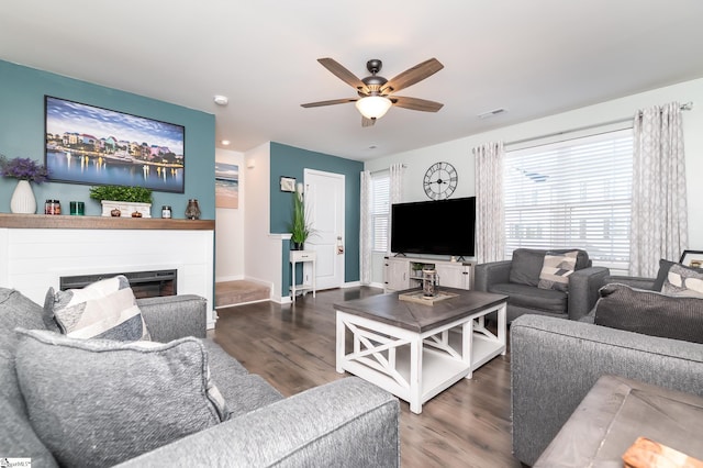 living room with ceiling fan and dark hardwood / wood-style flooring