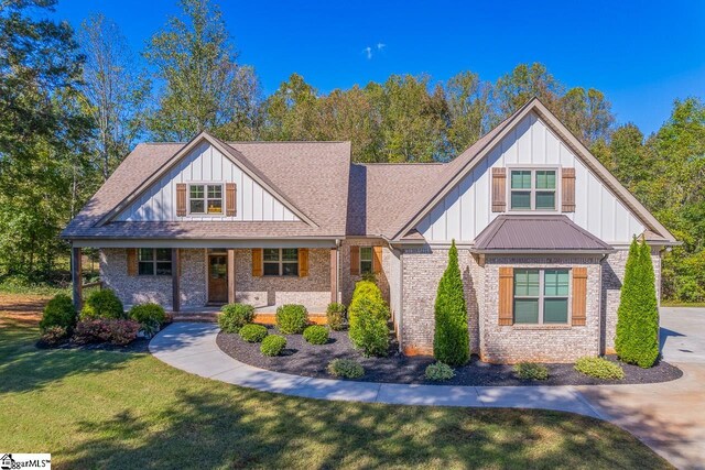 craftsman inspired home with a porch and a front lawn