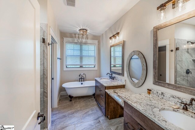 bathroom featuring vanity and independent shower and bath