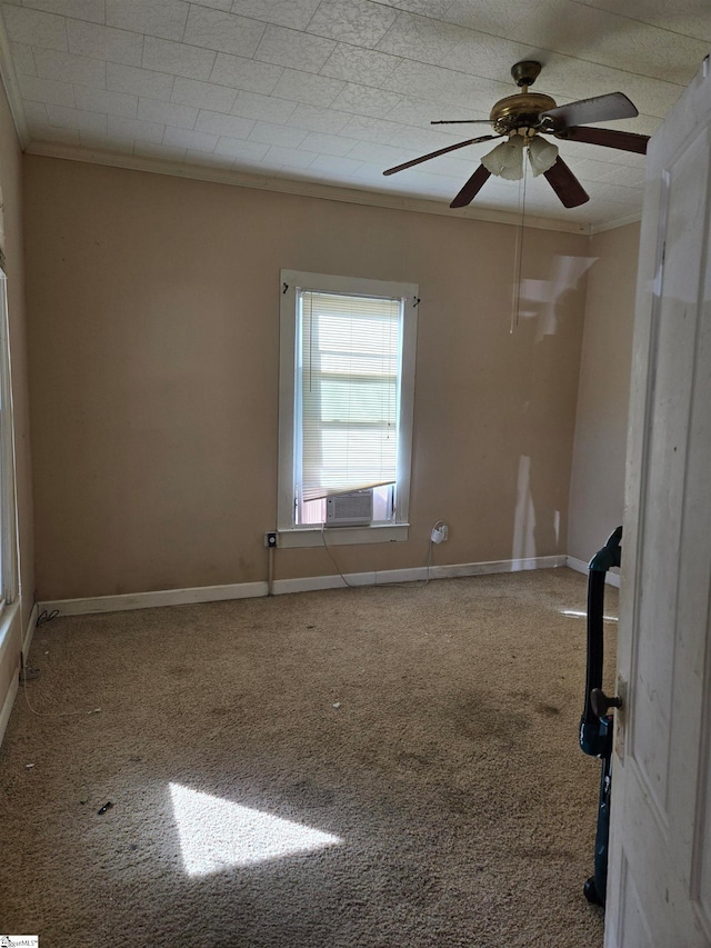 spare room with ornamental molding, carpet, and ceiling fan