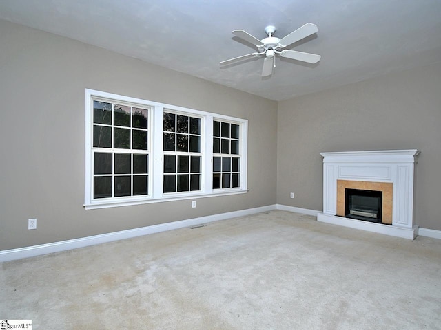 unfurnished living room featuring light colored carpet and ceiling fan