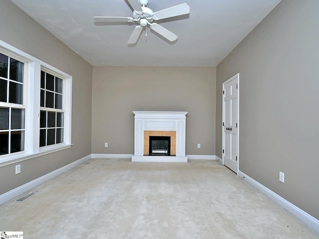 unfurnished living room with light carpet and ceiling fan