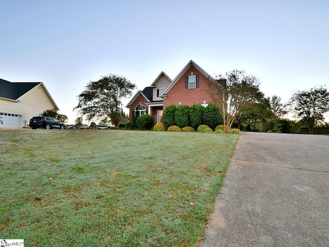 view of front of property with a front lawn and a garage