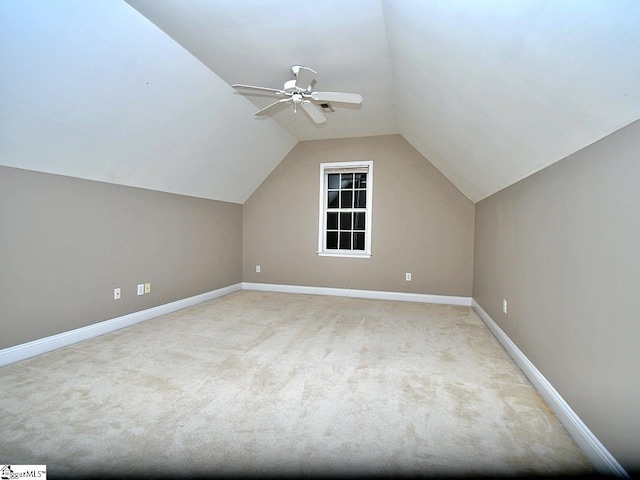 bonus room with ceiling fan, vaulted ceiling, and light colored carpet