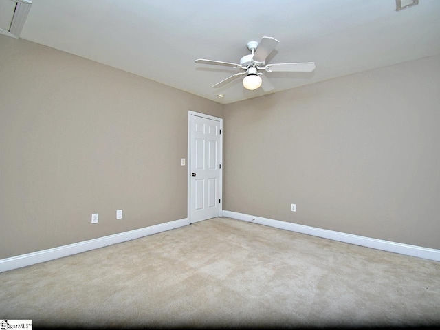 carpeted spare room with ceiling fan