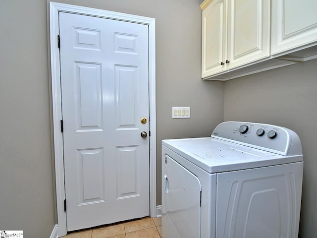 laundry area featuring light tile patterned floors, cabinets, and washer / clothes dryer