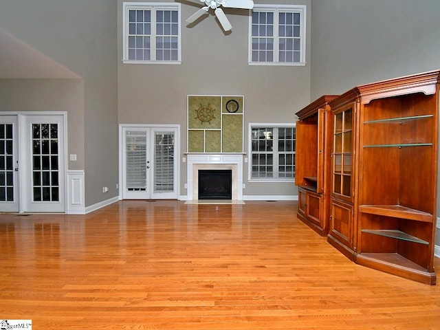 unfurnished living room featuring french doors, light hardwood / wood-style floors, and ceiling fan