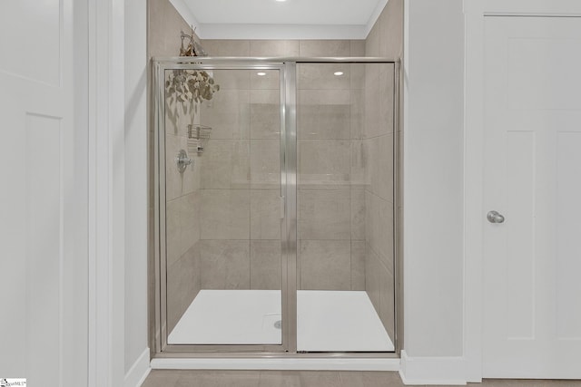 bathroom with a shower with door