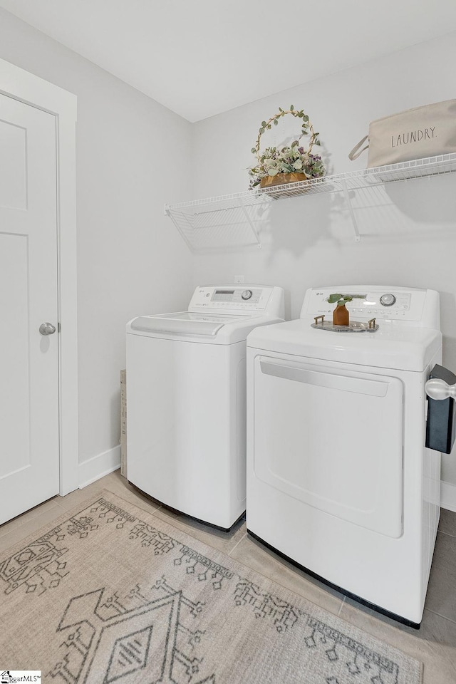26 Shorncliffe Rd, Simpsonville, SC 29680 - laundry area featuring baseboards, light tile patterned floors, separate washer and dryer, and laundry area