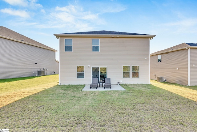 back of house with cooling unit, a patio area, and a lawn