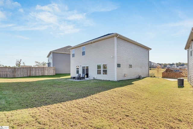 rear view of house featuring a patio area and a lawn