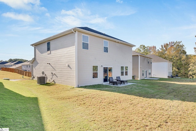 rear view of house with a patio area, central AC, and a lawn