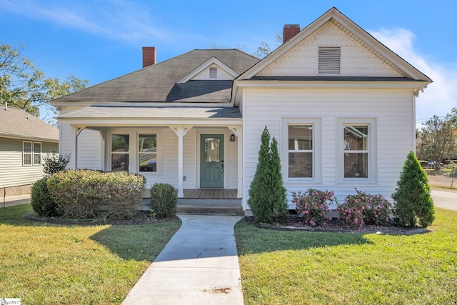 view of front of house featuring a front yard and covered porch