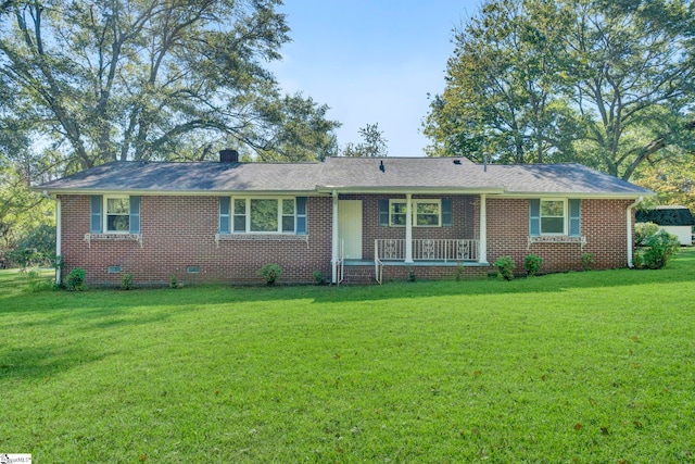 ranch-style house featuring a porch, brick siding, a chimney, and a front yard