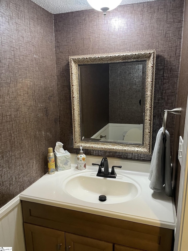 bathroom featuring vanity and a textured ceiling