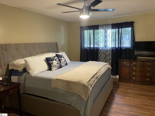 bedroom with ceiling fan and dark hardwood / wood-style flooring