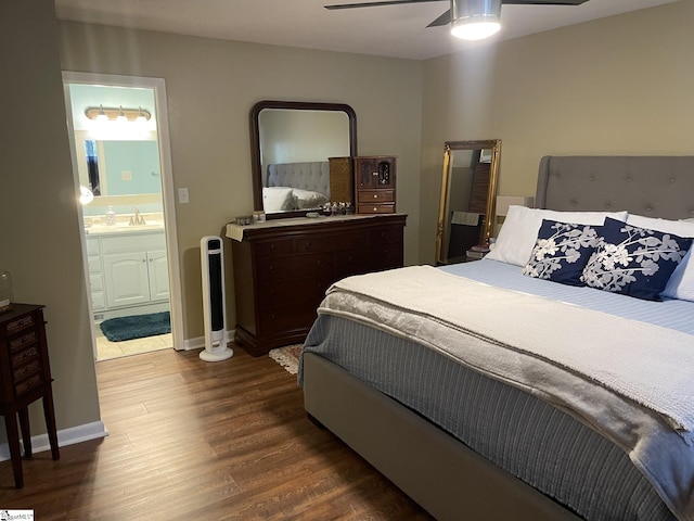 bedroom with hardwood / wood-style floors, ensuite bathroom, sink, and ceiling fan