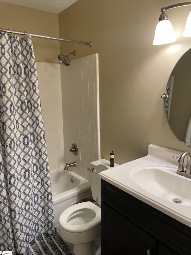 full bathroom with vanity, a textured ceiling, shower / tub combo with curtain, and toilet