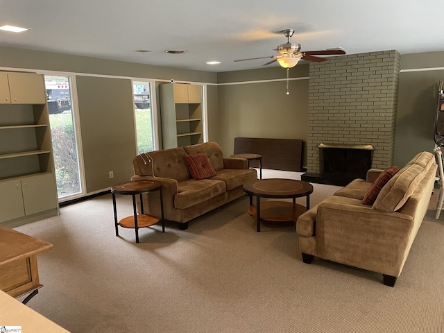 living room with ceiling fan, a fireplace, and light colored carpet