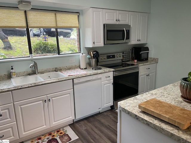 kitchen featuring white cabinetry, stainless steel appliances, sink, and dark hardwood / wood-style flooring