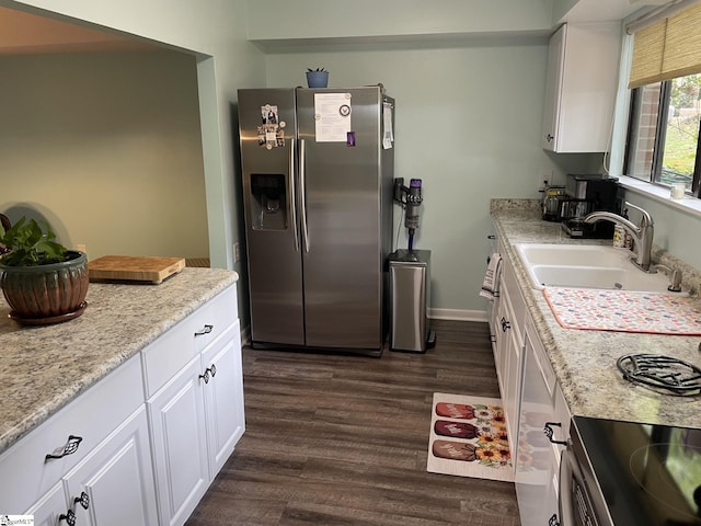 kitchen featuring dark wood-type flooring, sink, light stone countertops, stainless steel fridge with ice dispenser, and white cabinetry