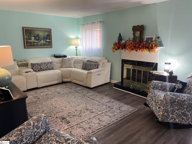 living room featuring a high end fireplace and hardwood / wood-style floors