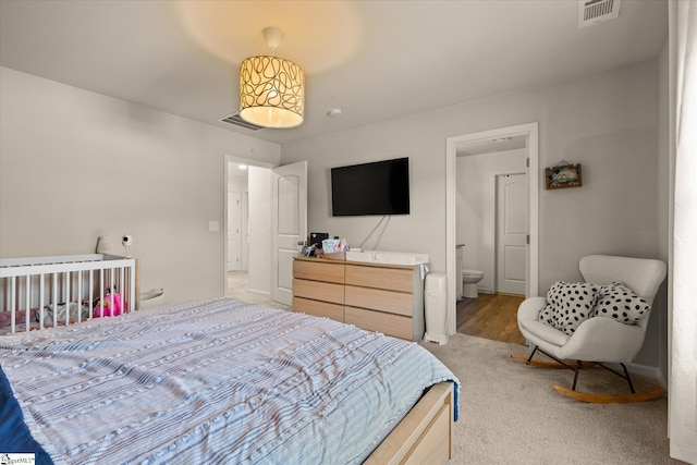 carpeted bedroom with ensuite bathroom