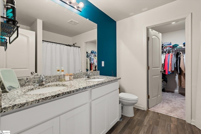 bathroom with vanity, hardwood / wood-style flooring, and toilet