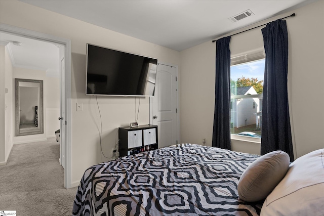 bedroom featuring ornamental molding and light carpet