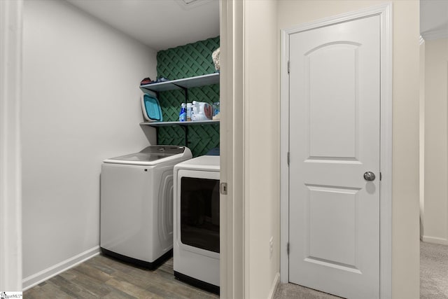 washroom featuring hardwood / wood-style floors and separate washer and dryer