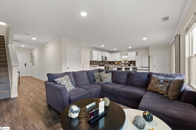 living room with ornamental molding and hardwood / wood-style flooring