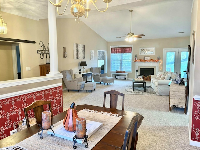 dining area featuring ornate columns, vaulted ceiling, carpet flooring, and a wealth of natural light