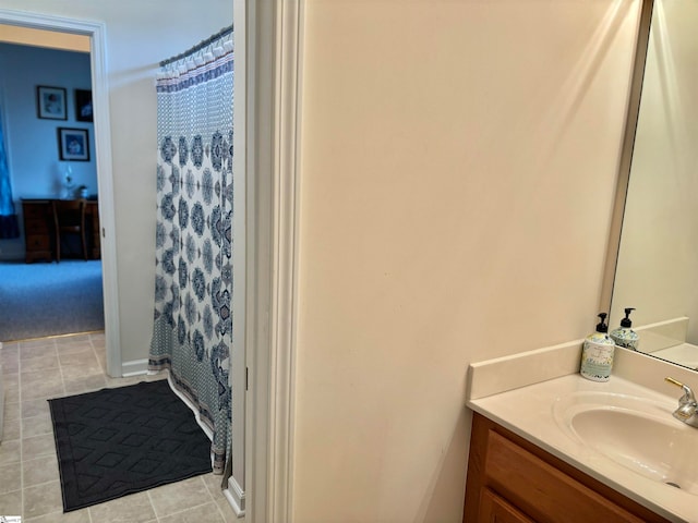 bathroom featuring vanity, walk in shower, and tile patterned floors