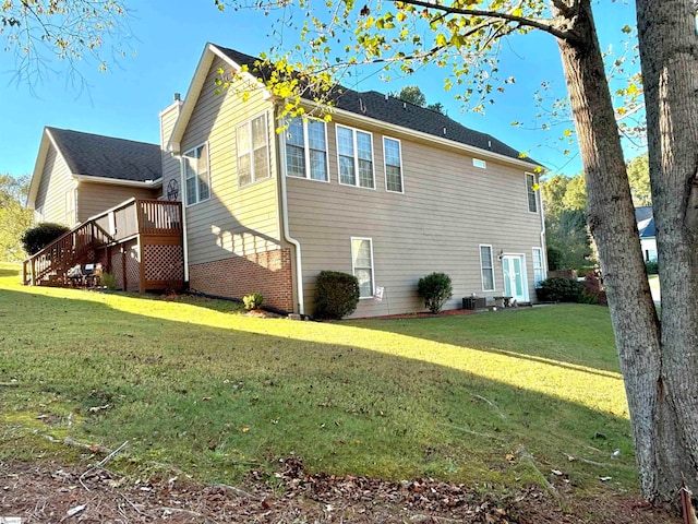 view of home's exterior with a wooden deck, a lawn, and cooling unit