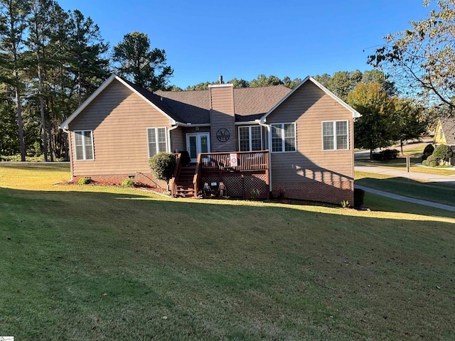 rear view of house featuring a deck and a lawn