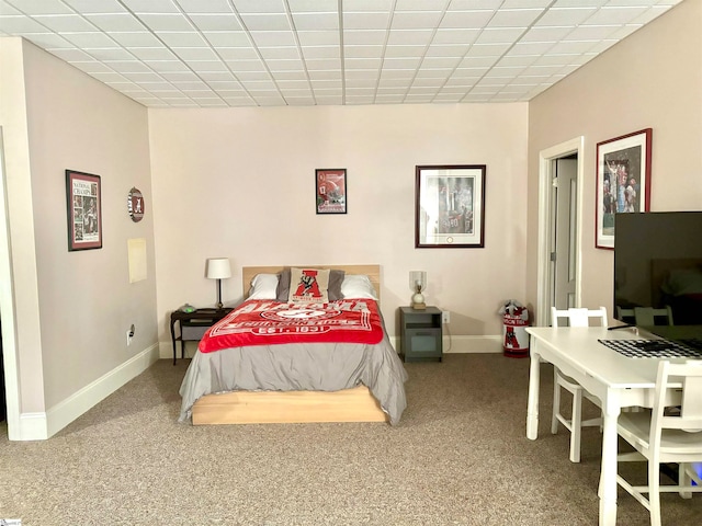 carpeted bedroom with a drop ceiling