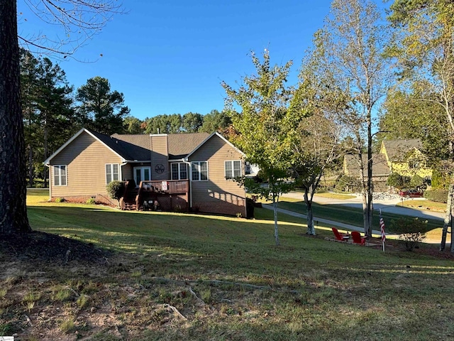 exterior space featuring a deck and a lawn